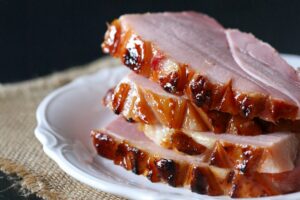 Pineapple bourbon glazed ham on a platter, Pineapple bourbon butter glazed ham recipe served with sides, Easter Ham Glaze, Christmas Ham Recipe, Ham Glaze Recipe, Jones Dairy Farm Ham