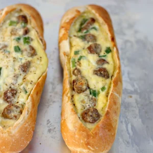 12:40 PMClaude responded: Two breakfast sausage egg boats made from hollowed sourdough baguettes filled with baked eggs, Jones Dairy Farm Golden Brown All Natural Pork Sausage Links, me…Two breakfast sausage egg boats made from hollowed sourdough baguettes filled with baked eggs, Jones Dairy Farm Golden Brown All Natural Pork Sausage Links, melted pepper jack cheese, and sliced green onions.