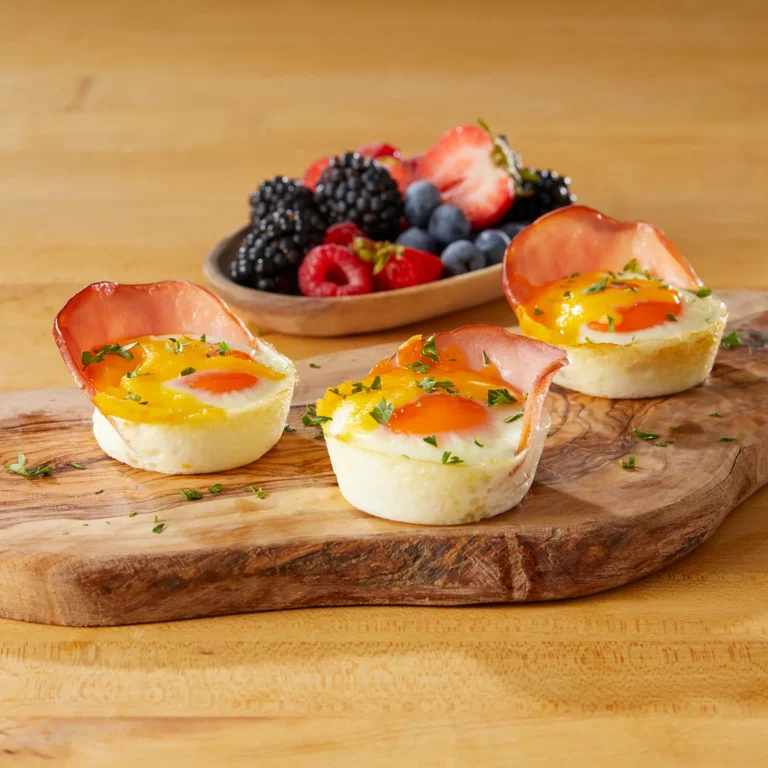 7:36 PMClaude responded: Three baked Canadian bacon and egg cups garnished with fresh herbs, served on a rustic wood board alongside a bowl of mixed fresh berries.Three baked Canadian bacon and egg cups garnished with fresh herbs, served on a rustic wood board alongside a bowl of mixed fresh berries.