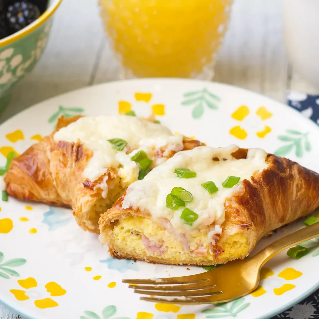 11:10 AMClaude responded: Two stuffed breakfast croissants filled with egg and Jones Canadian Bacon, topped with melted Swiss cheese sauce and chopped scallions, served on a floral plat…Two stuffed breakfast croissants filled with egg and Jones Canadian Bacon, topped with melted Swiss cheese sauce and chopped scallions, served on a floral plate with a gold fork.