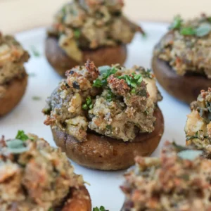 9:24 AMClaude responded: Whole stuffed mushroom caps filled with golden-baked Jones pork sausage, sage, and dairy-free cream cheese, garnished with fresh chopped parsley, arranged on a…Whole stuffed mushroom caps filled with golden-baked Jones pork sausage, sage, and dairy-free cream cheese, garnished with fresh chopped parsley, arranged on a white platter.
