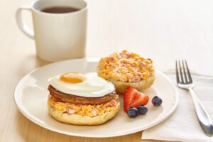 Jones sausage patty and fried egg breakfast sandwich with house-made pimento cheese on a toasted buttermilk biscuit