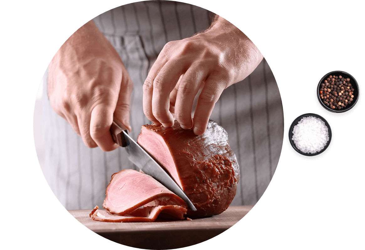 Chef slicing Ham