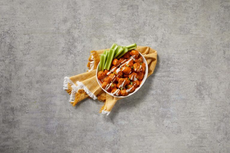 Chicken meatballs in a buffalo sauce with celery sticks, Jones Dairy Farm Chicken Meatballs, Gluten free meatballs, Precooked Chicken Meatballs