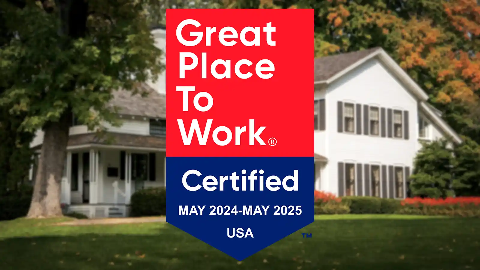 Great Place To Work Certified badge for May 2023–May 2024, USA, displayed over a blurred photo of the Jones Dairy Farm farmhouse in Fort Atkinson, Wisconsin.