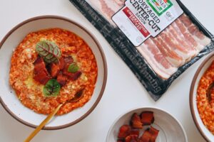 A bowl of Amatriciana Risotto, made with Jones Dairy Farm Dry Aged Cherrywood Smoked Bacon.