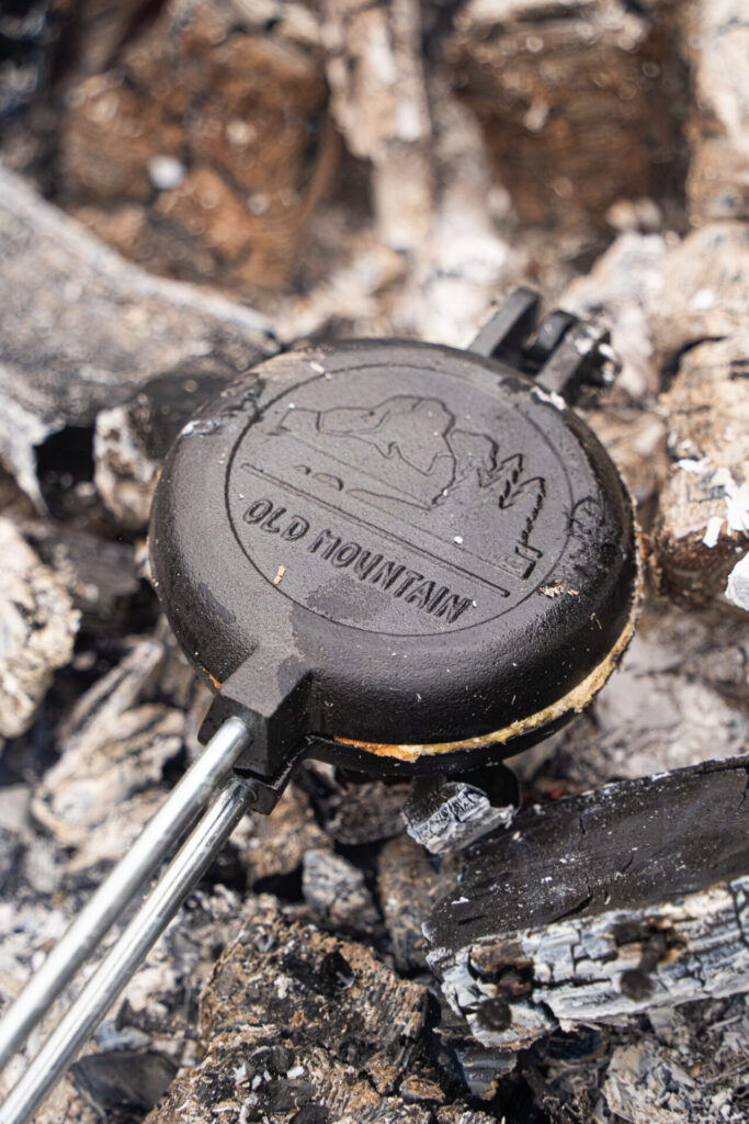 Pie iron over campfire Pie iron over campfire, Easy camping recipes, camping breakfast, camping breakfast ideas