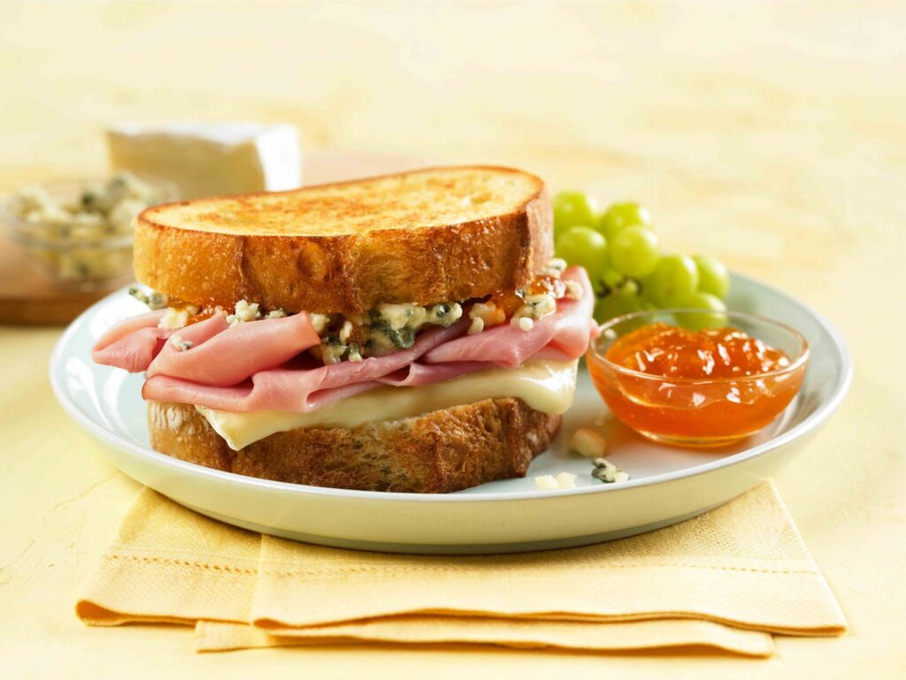 Whole-muscle ham sliced for sandwiches in restaurant kitchen, Why Jones Ham is the Top Choice for Foodservice and Catering, foodservice ham, catering ham, glazed ham foodservice, carving station ham