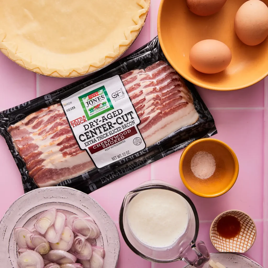 Ingredients for Quiche Lorraine including Jones Dairy Farm Dry Aged Center-Cut Bacon, eggs, pie crust, shallots, heavy cream, salt, and hot sauce