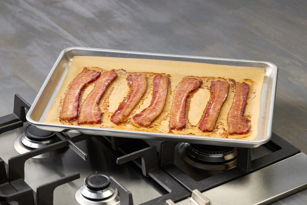 bacon cooked in the oven on a sheet pan, how to cook bacon in the oven, oven bacon, oven baked bacon