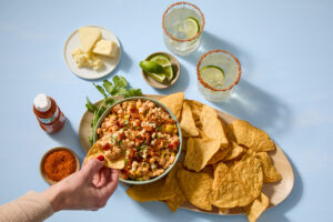 Mexican street corn dip with Jones Dairy Farm bacon, Cotija cheese, and Tajín served with tortilla chips