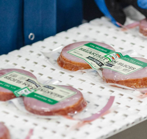 Canadian bacon product on manufacturing line getting packaged up