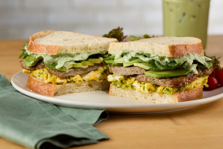 Green goddess breakfast sandwich with Jones Dairy Farm turkey sausage, scrambled eggs, avocado, and spinach on toasted sourdough
