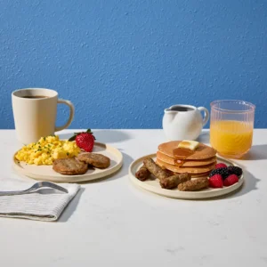 Jones Dairy Farm all natural breakfast sausage patties and links served with scrambled eggs, pancakes, and fresh fruit