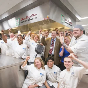 Philip Jones and culinary students celebrating at the Jones Dairy Farm Advanced Culinary Lab at Madison College