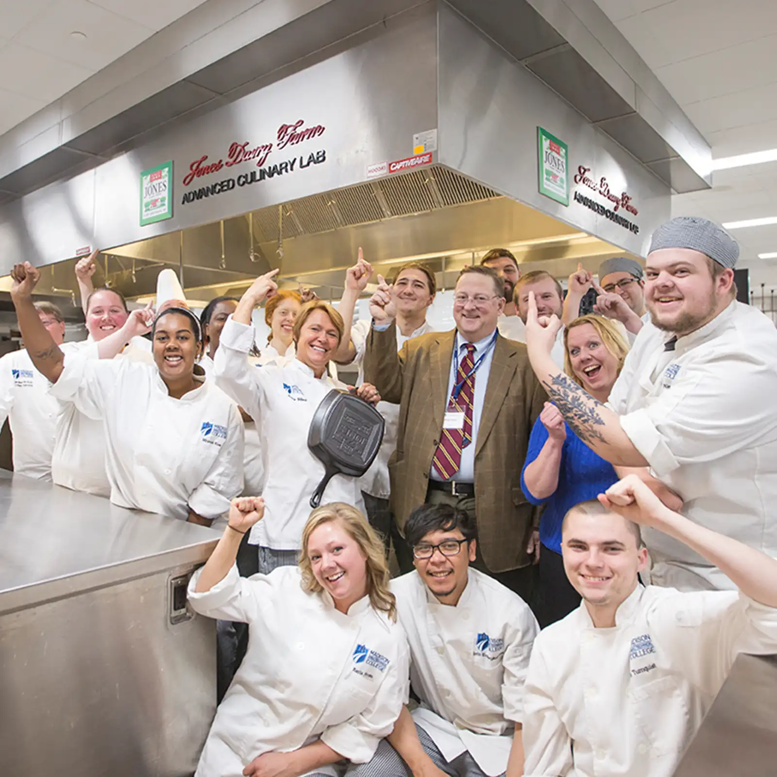 Philip Jones and culinary students celebrating at the Jones Dairy Farm Advanced Culinary Lab at Madison College