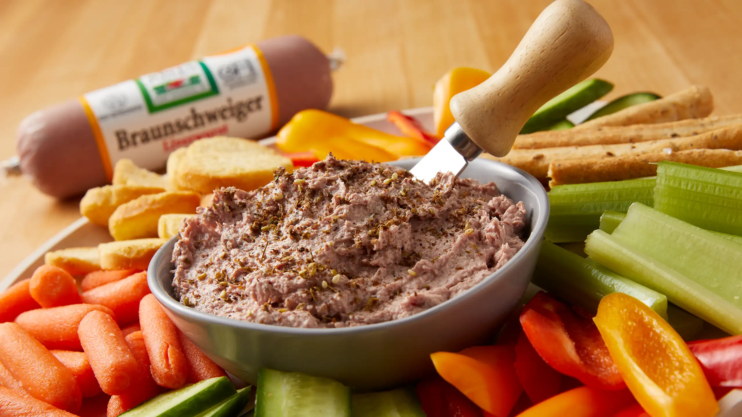 Jones Dairy Farm Braunschweiger liverwurst dip served with fresh vegetables, crackers, and breadsticks