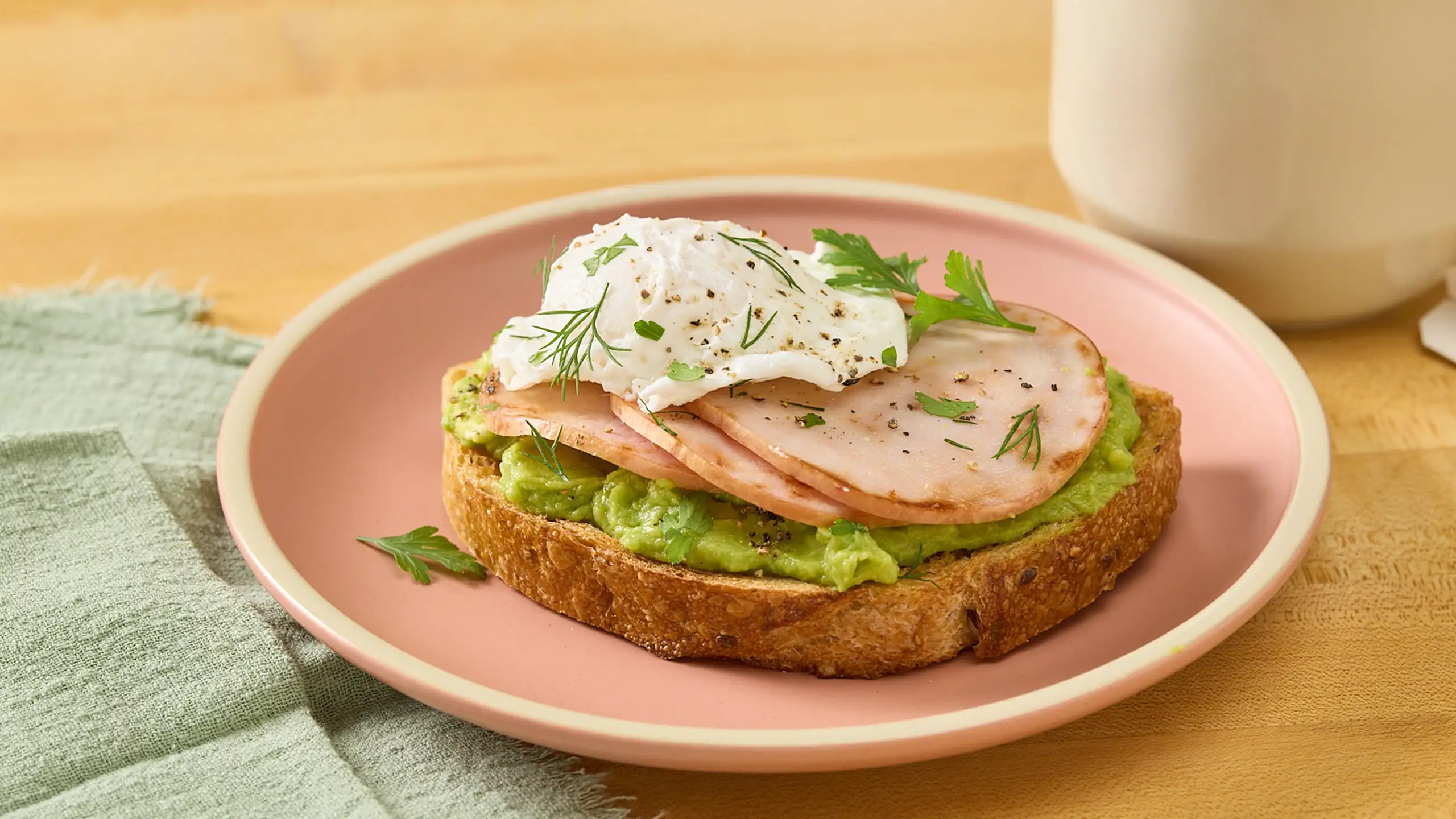 Jones Dairy Farm Canadian bacon with avocado and a poached egg on toasted multigrain bread