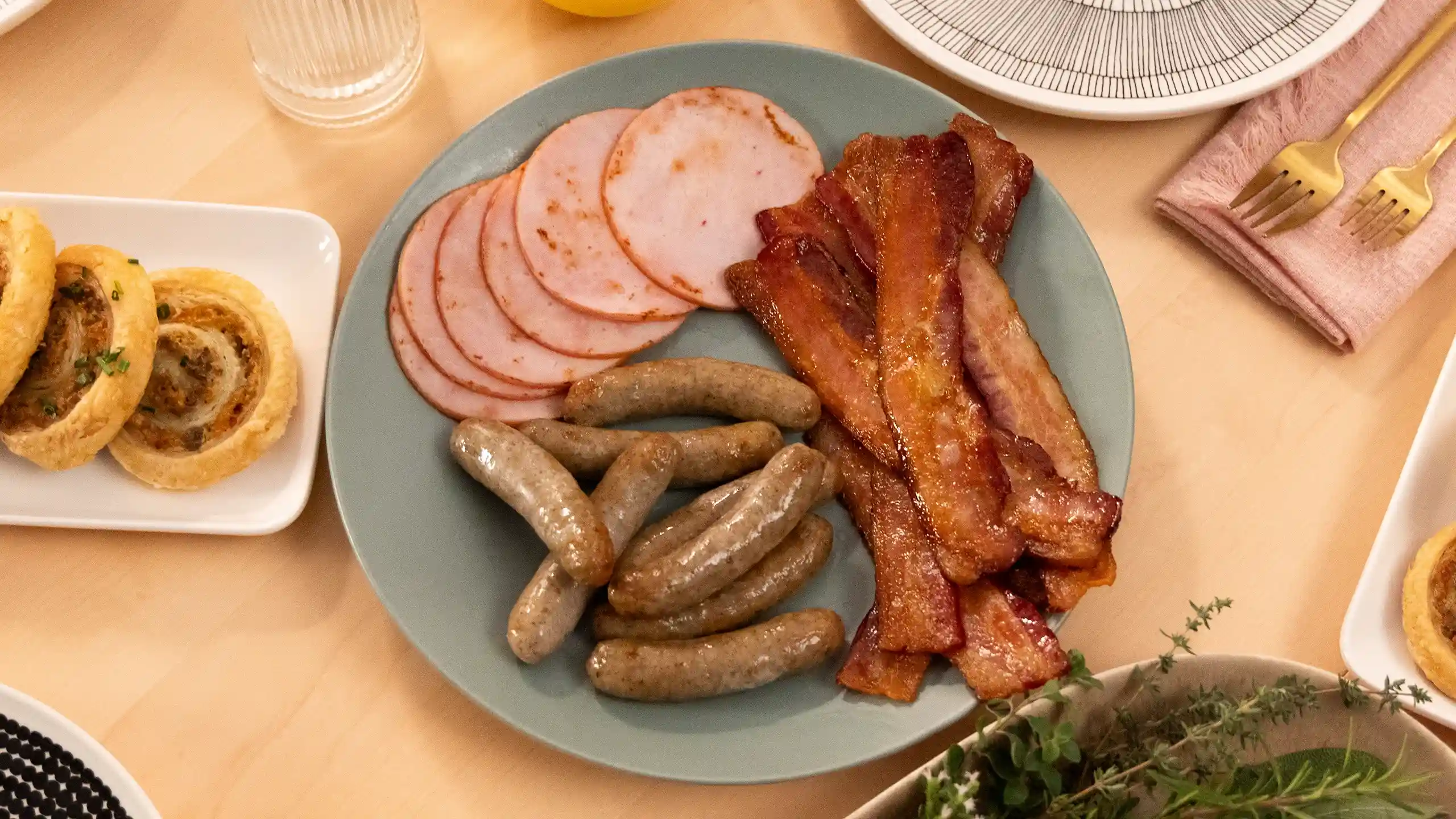 Jones Dairy Farm Canadian bacon, breakfast sausage links, and bacon strips on a brunch tablescape