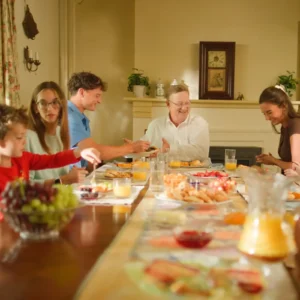 Philip Jones laughs with grandchildren, nieces, and nephews around a breakfast table