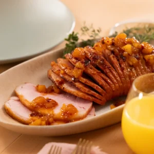 Jones Dairy Farm sliced ham with pineapple glaze on a serving platter with orange juice