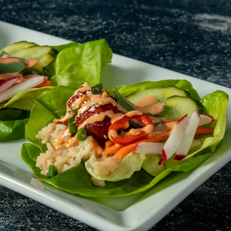 Jones Dairy Farm pork and bacon meatball lettuce wraps with rice, cucumber, radish, and sriracha aioli