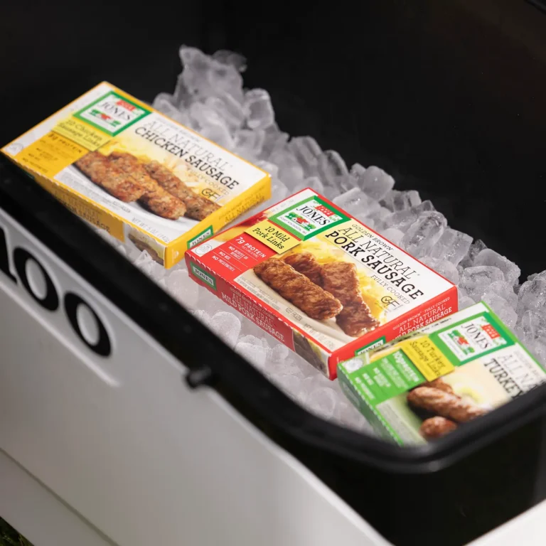 Three boxes of Jones Golden Brown Sausage in a cooler filled with ice