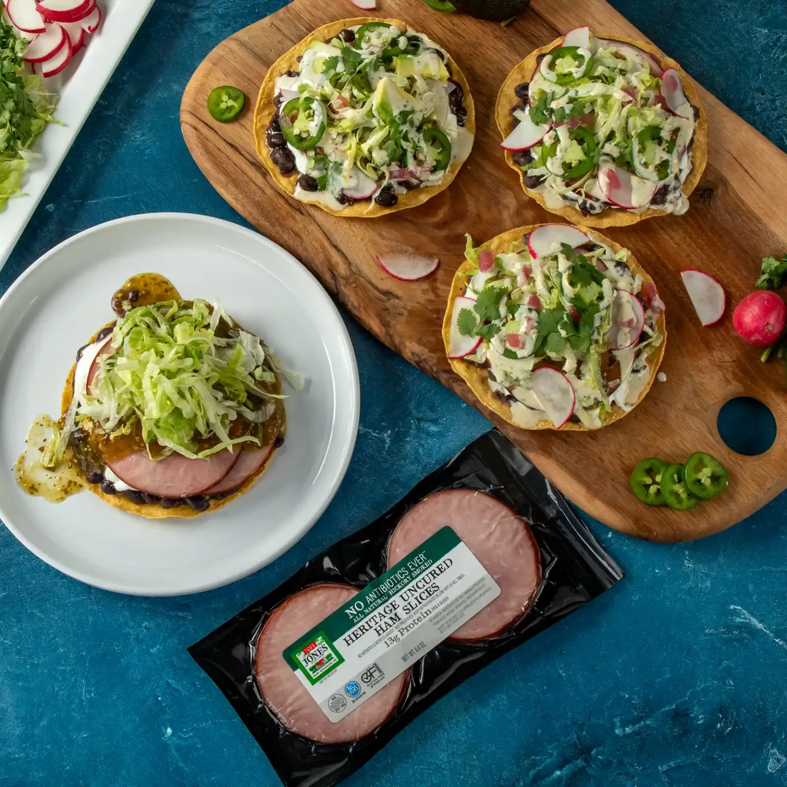 Jones Dairy Farm heritage uncured ham slices package with ham tostadas topped with black beans, radish, shredded lettuce, and cilantro