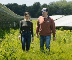 Lisa and Will Jones walking through the solar panel array at Jones Dairy Farm