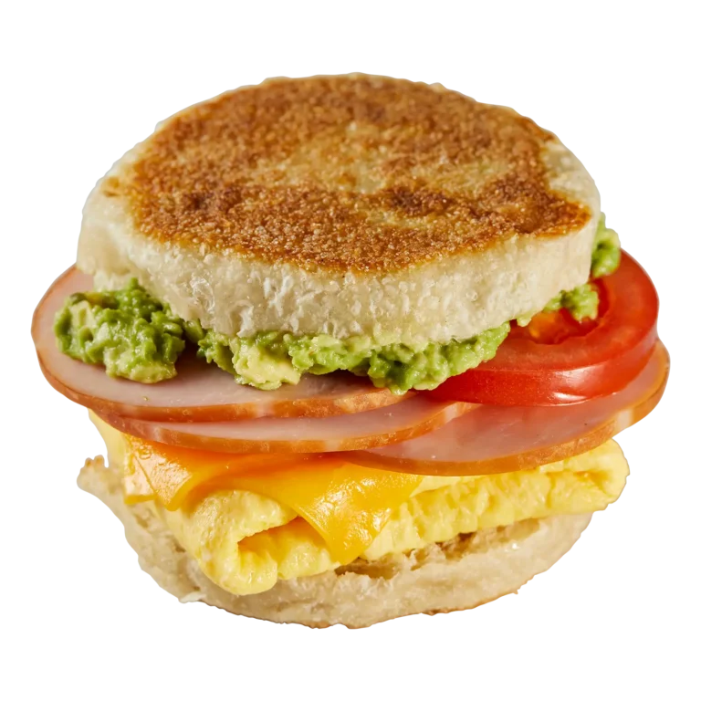 Jones Dairy Farm Canadian bacon on a toasted English muffin breakfast sandwich with scrambled egg, cheddar cheese, tomato, and avocado.
