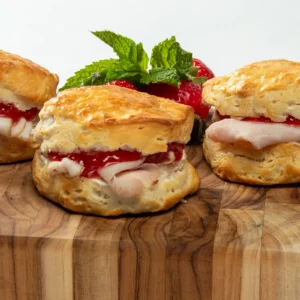 Jones Heritage Uncured Ham, whipped goat cheese, and strawberry jam on hand-carved buttermilk biscuit sliders with fresh strawberries and mint