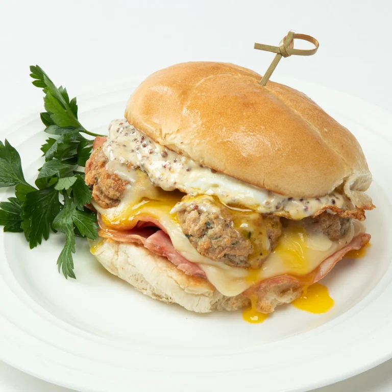 Jones Dairy Farm chicken meatball morning smash stack sandwich with ham, a fried egg, melted cheese, and whole grain mustard aioli on a brioche bun