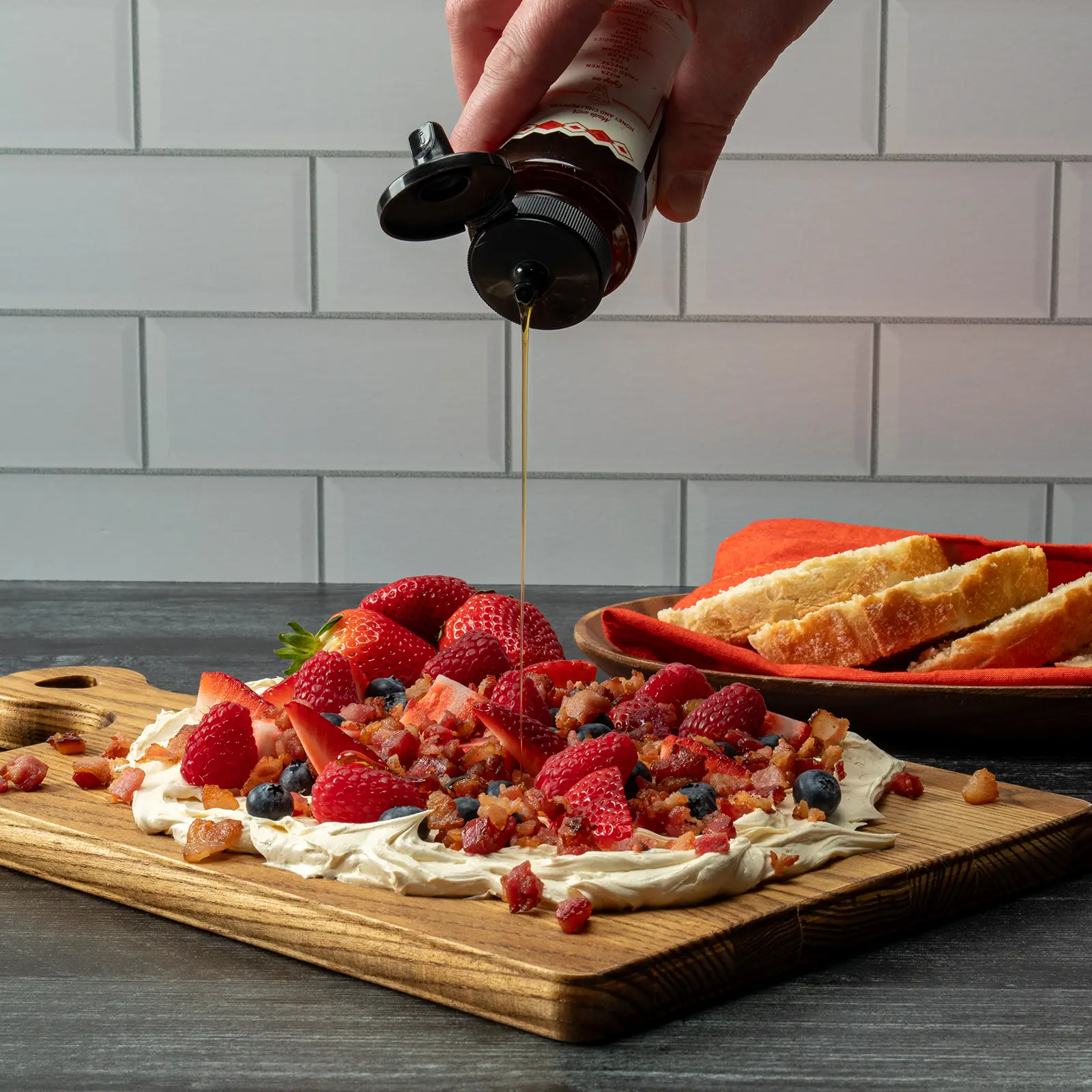 Sunrise Butter Board with whipped butter, fresh berries, and Jones Raw Diced Bacon, finished with a hot honey drizzle