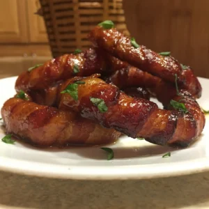 Bacon-wrapped onion rings glazed and garnished with parsley, made with Jones bacon