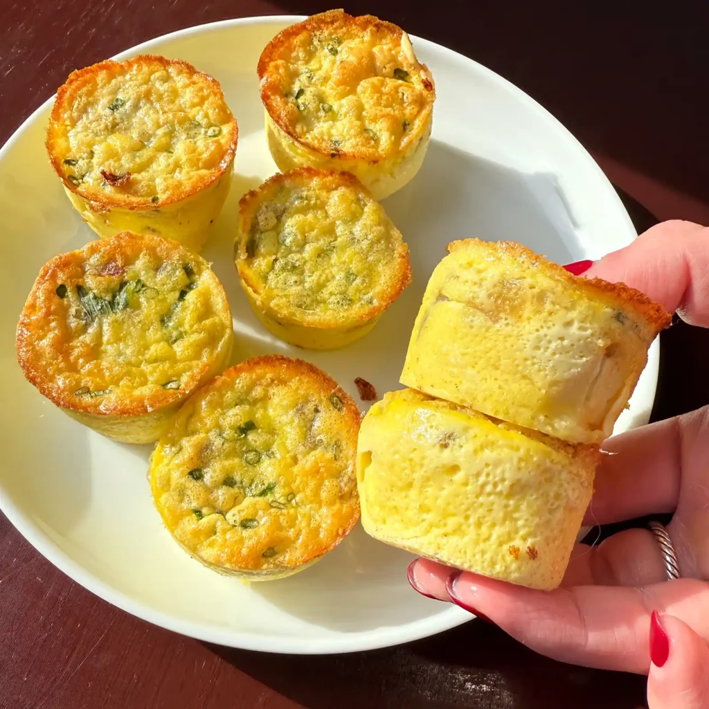 High protein sausage egg cups cut in half showing sausage and egg filling, made with Jones sausage links.