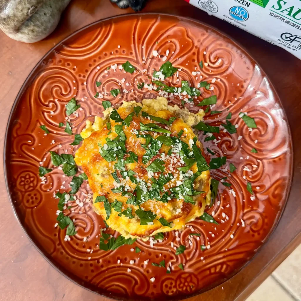 Single serve sausage breakfast casserole topped with parsley and parmesan, made with Jones sausage.