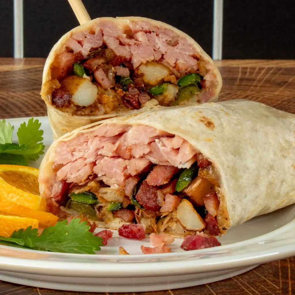 Close-up of pulled bacon burrito filling with diced potatoes, sautéed poblano peppers, shredded pulled bacon, and diced bacon